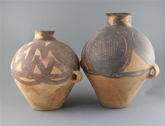 Two Chinese terracotta two handled jars, Neolithic period or later, H.32.5cm and 40cm